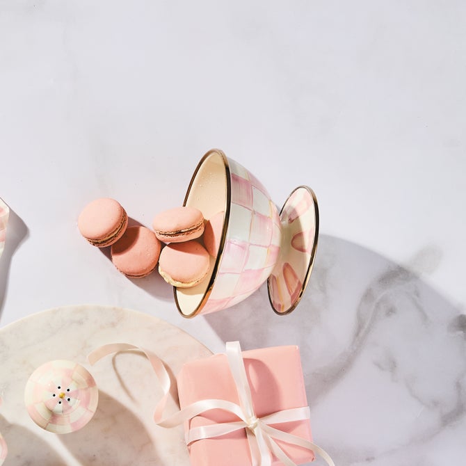 MacKenzie-Childs Rosy Check Ice Cream Dish displayed with pink macarons, checkered shaker, and gift box on a marble serving board.