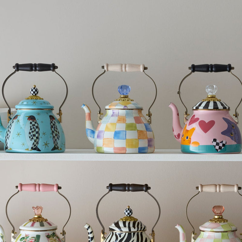 Mackenzie Childs | Confetti Check Tea Kettle, 2 QT., displayed among whimsical, hand-painted teapots on white shelves. Perfect for adding charm to your kitchen.