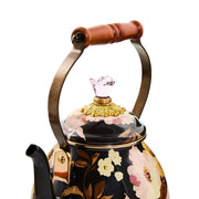 MacKenzie-Childs Brown Wild Rose Tea Kettle, 2 QT., features a black floral pattern, acacia wood handle, and pink glass finial, perfect for elegant kitchens.