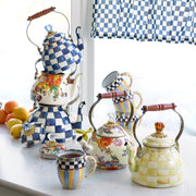 MacKenzie Childs | Royal Check Tea Kettle, 2 QT. displayed with floral and checked kettles, striped mug, and citrus, on a bright kitchen countertop.