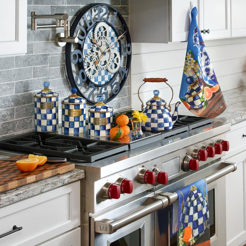 MacKenzie Childs | Royal Check Tea Kettle, 2 QT, on a stove, surrounded by matching blue-and-white checkered ceramics in a farmhouse-style kitchen.