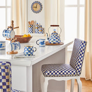 MacKenzie Childs | Royal Check Tea Kettle, 2 QT. sits on a white counter with matching mugs and canisters in a bright, inviting kitchen scene.