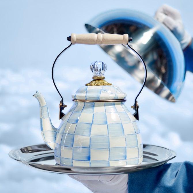 MacKenzie-Childs Sky Check Tea Kettle, 2 Qt, on a silver tray, features hand-painted checks, a wooden handle, and a glass finial lid with brass accents.