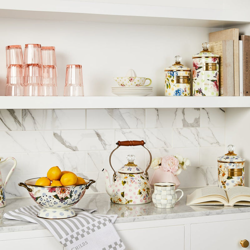 MacKenzie Childs Wildflowers Pink Tea Kettle, 2 QT, features hand-applied floral designs, a wood handle, and a glass-topped lid, showcased in a vintage kitchen setting.