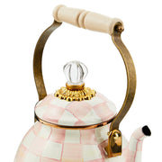 MacKenzie Childs | Rosy Check Tea Kettle, 2 QT, features a pink-and-white checkerboard ceramic design, brass-tone handle, and a clear glass knob, embodying elegant craftsmanship.