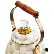 MacKenzie Childs | Mocha Check Tea Kettle, 2 QT., features a ceramic body with hand-painted checks, wooden handle, and a crystal-style knob on gold fittings.