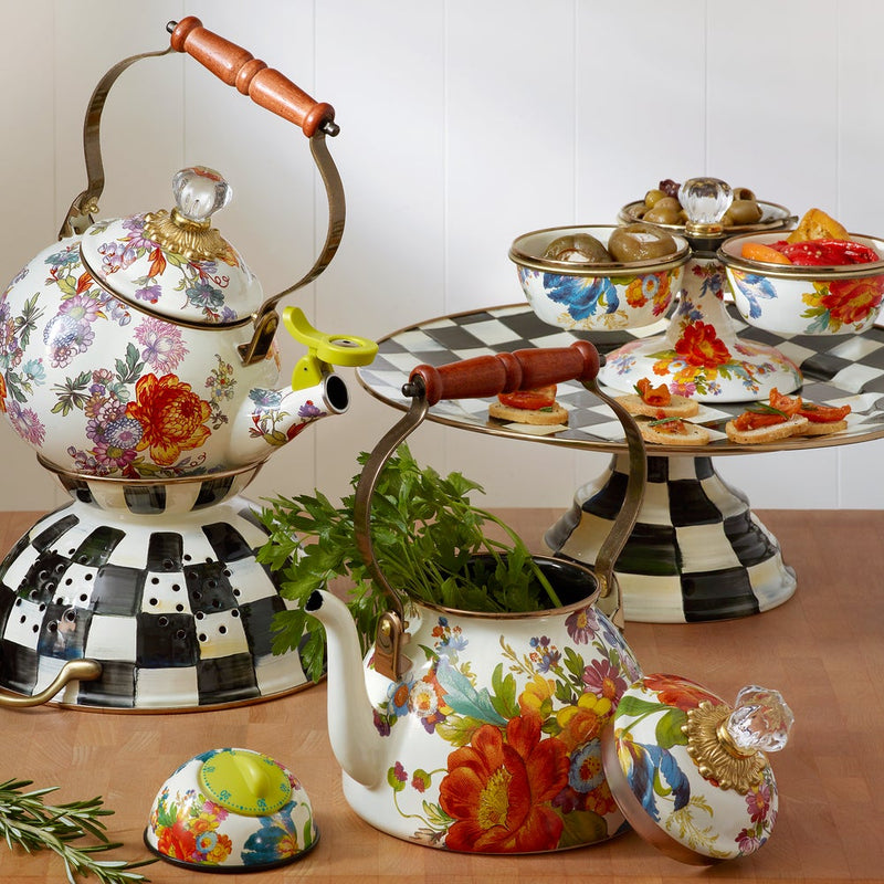MacKenzie-Childs White Flower Market 2 Quart Tea Kettle with floral design, showcased with herbs and tiered platter, embodying eclectic, cheerful tea-time elegance.
