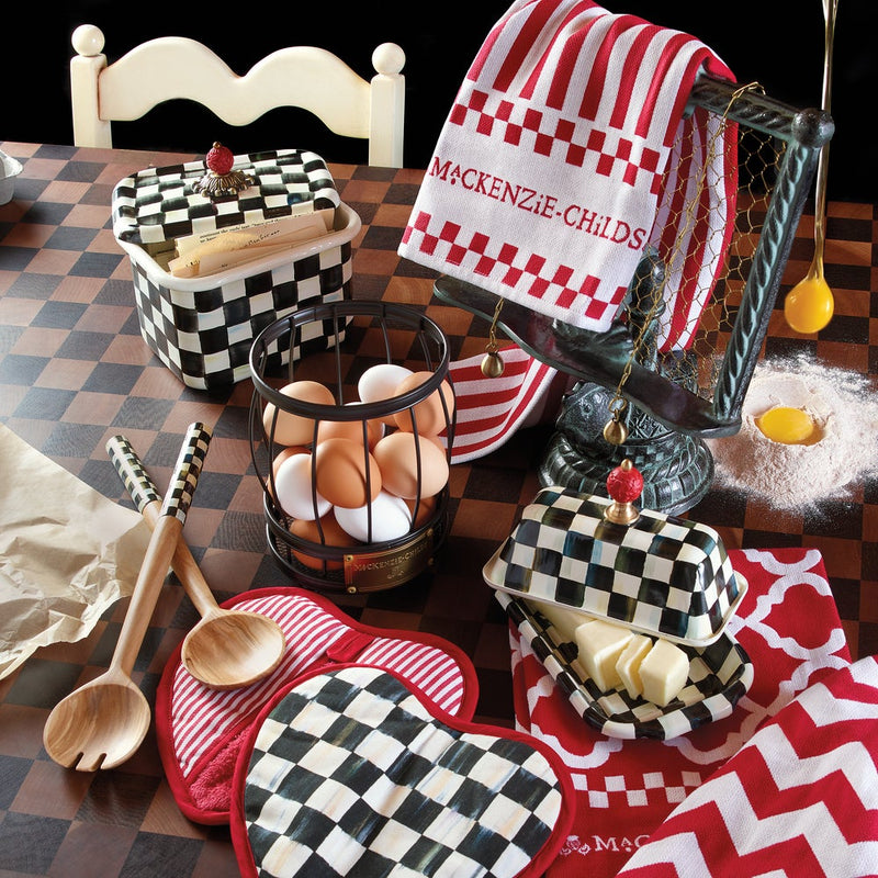 MacKenzie-Childs Courtly Check Recipe Box on a tabletop with wooden spoons, egg basket, butter dish, and linens, embodying vintage charm and culinary elegance.