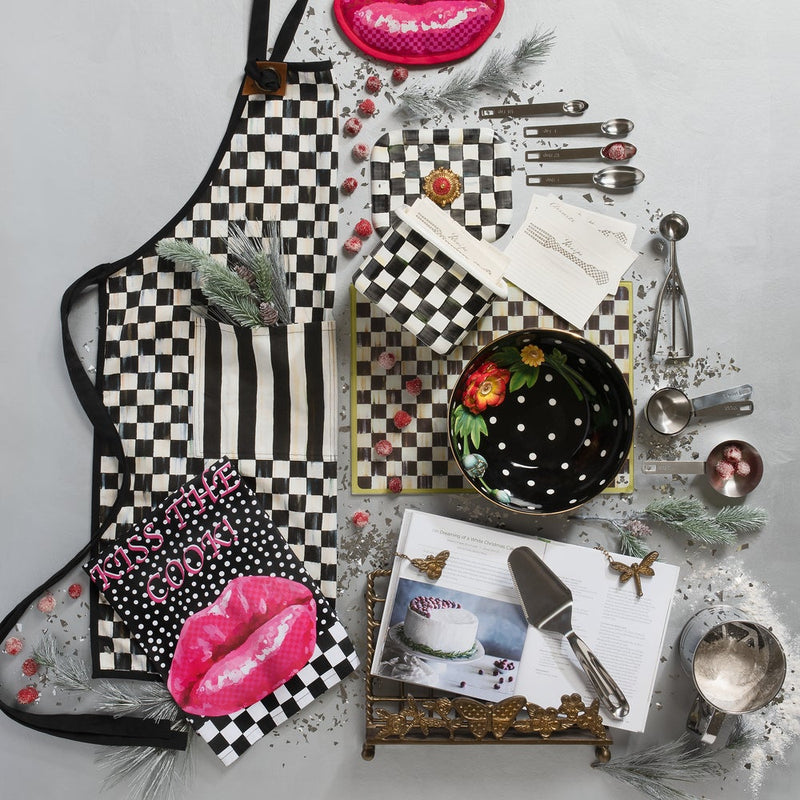 Stylized flat-lay featuring MacKenzie-Childs Courtly Check Recipe Box with recipe cards, cookbook, and baking tools, showcasing elegant kitchen organization and decorative flair.