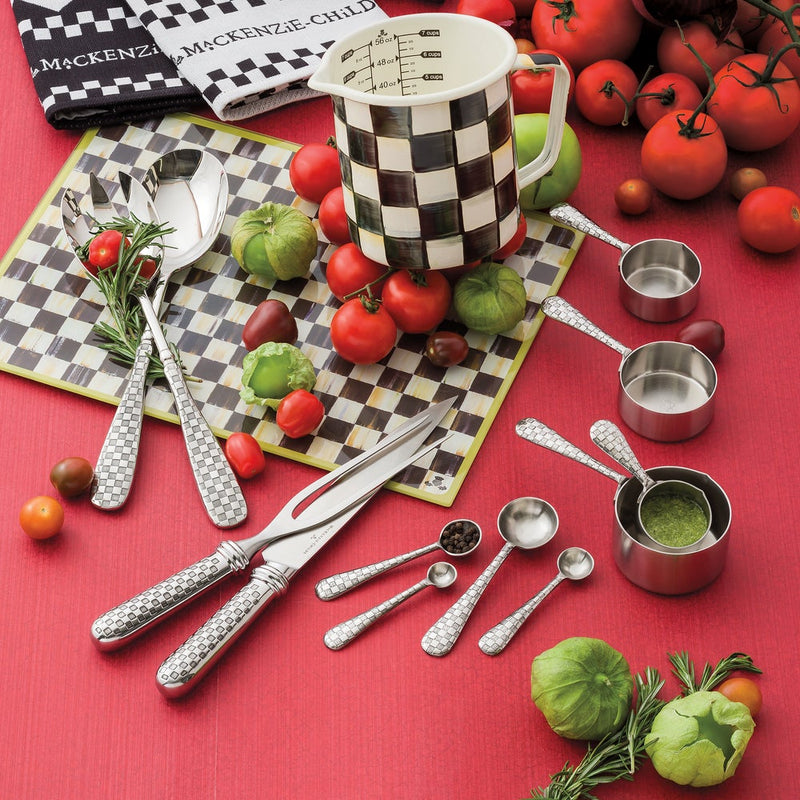 MacKenzie-Childs Courtly Check 7 Cup Measuring Cup with checkerboard design, surrounded by fresh tomatoes, tomatillos, rosemary, and matching utensils, highlighting elegance and practicality.