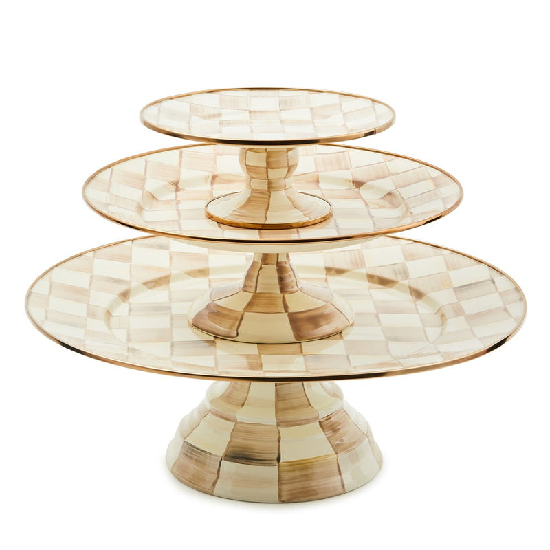 MacKenzie Childs | Mocha Check Large Pedestal Platter on a three-tiered stand, featuring hand-painted checks and bronzed stainless steel rim, ideal for elegant gatherings.