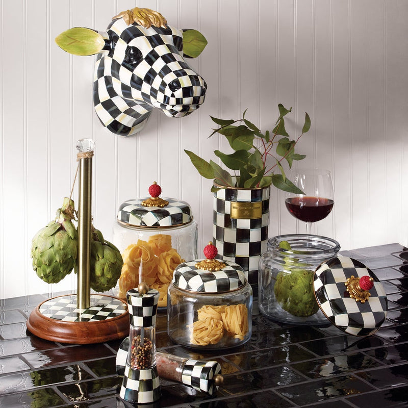 MacKenzie Childs | Courtly Check Utensil Holder amid a checker-patterned vignette with jars, artichokes, and a wine glass, showcasing Athens Cooks' curated kitchen elegance.