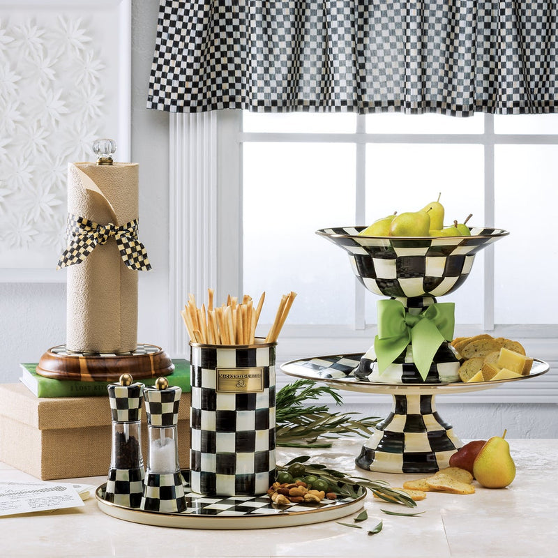 MacKenzie Childs | Courtly Check Utensil Holder on a checkerboard tray with matching serveware, filled with breadsticks, surrounded by styled pears, cheese, and greenery.
