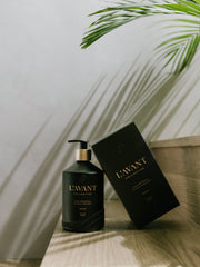 L'AVANT Collective - Fresh Linen Hand Soap in a matte black glass bottle with accompanying box, embodying eco-luxe sophistication and sustainability.