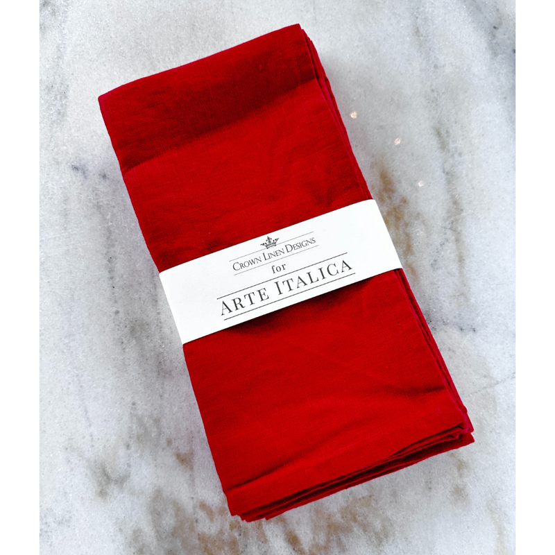 Arte Italica & Crown Linen Designs red linen napkin set, wrapped in branded paper, displayed on a marble surface, highlighting casual elegance for Athens Cooks' kitchen collection.