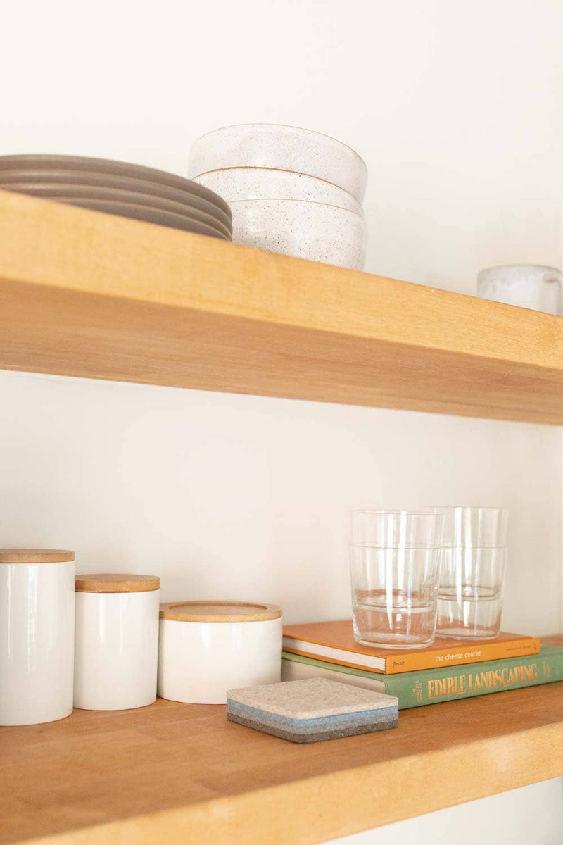 Graf Lantz - Bierfilzl Merino Wool Felt Square Coaster Multi 4 Pack: Cobblestone displayed on a shelf with kitchenware, emphasizing modern, refined home decor.