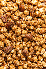 Poppy Hand-Crafted Popcorn - Cinnamon Bourbon Pecan Popcorn features caramel-coated popcorn with praline pecans, offering a Southern-inspired, gluten-free snack experience.