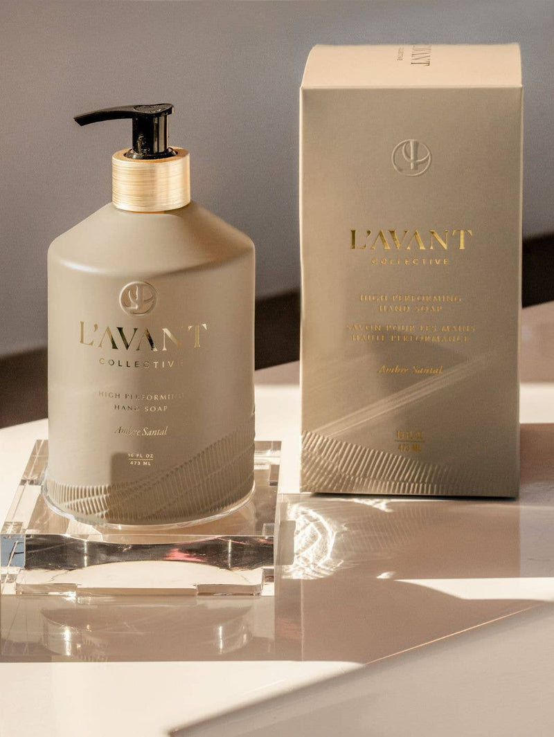 L'AVANT Collective - Hand Soap Ambre Santal in a matte taupe bottle with black pump, accompanied by a matching branded box, reflecting luxury and eco-conscious design.