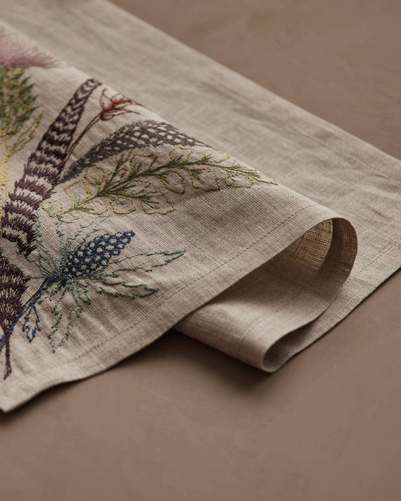 Coral & Tusk - Thistle Dinner Napkin: Hand-embroidered linen napkin featuring delicate botanical motifs in muted tones, perfect for an elegant autumnal table setting.