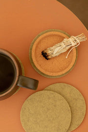 Graf Lantz - Bierfilzl Merino Wool Felt Round Coaster Solid 4 Pack: Sage, shown with a cup and saucer, highlighting the coaster's protective surface.