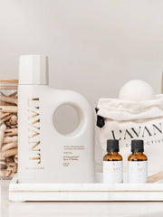 L'AVANT Collective Laundry Detergent Fresh Linen kit featuring detergent, essential oils, clothespins, and wool dryer balls, ideal for eco-friendly and gentle laundry care.