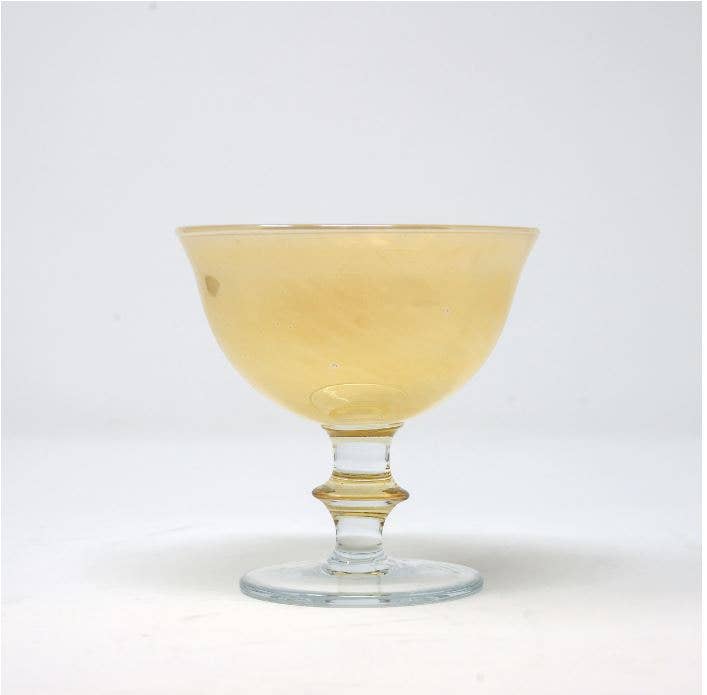 Rialto Compote in Naples Yellow, a mouth-blown glass with a marble look, showcasing Italian craftsmanship from the Arte Italica & Crown Linen Designs collection.