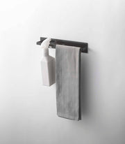 Yamazaki Home - Magnetic Kitchen Towel Hanger - Steel: White, wall-mounted with a hook holding a spray bottle and a bar with a light gray towel.