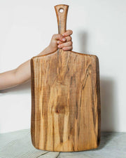 Petermans Boards and Bowls Inc. 27 Ambrosia Maple Serving Board with handle, elegantly crafted in New England, ideal for cutting or serving, available at Athens Cooks.