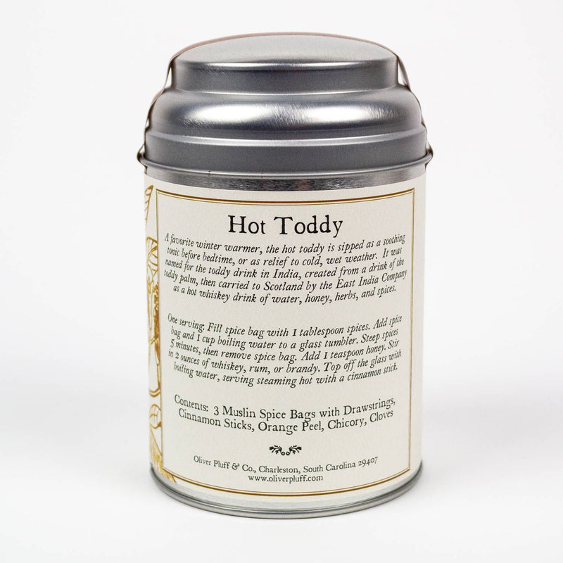 Oliver Pluff & Company - Orange Clove Hot Toddy Kit in a decorative tin, containing spices and instructions for crafting a warming honey-and-spice beverage.