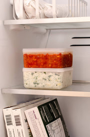 W&P Freezer Cube Storage Containers in a fridge, showing a set of three stackable sizes for efficient food storage and organization.