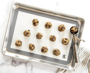 Nordic Ware | Small Cookie Dropper on baking sheet, showcasing uniform cookie dough portions for consistent baking results. Perfect tool for precision in baking.