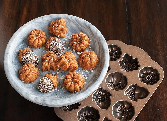 Nordic Ware | Autumn Delights Pan featuring acorn, maple leaf, and pumpkin shapes, perfect for baking 12 mini treats with fine detail and easy release.