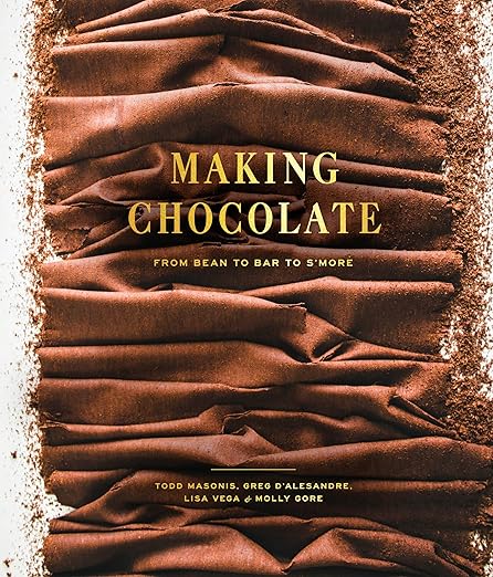Cover of Making Chocolate: From Bean to Bar to S’more by Todd Masonis, Greg D’Alesandre, Lisa Vega & Molly Gore, featuring chocolate shavings background.