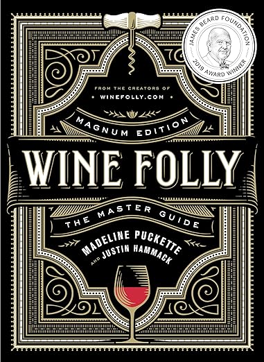 Cover of Wine Folly: Magnum Edition – The Master Guide, featuring art-deco design, highlighting wine expertise. Includes authors Madeline Puckette, Justin Hammack, and a 2019 James Beard Award medallion.