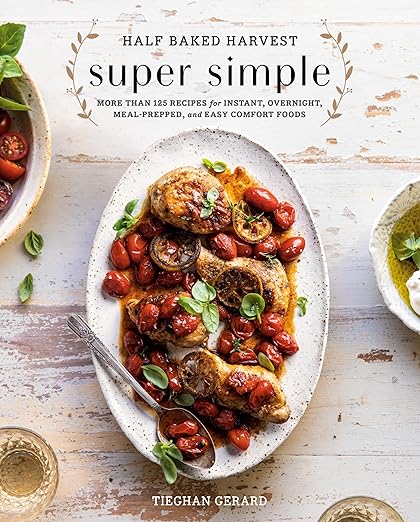 Cover of Half Baked Harvest Super Simple cookbook by Tieghan Gerard, featuring roasted chicken with tomatoes and basil, epitomizing easy, comforting, home-cooked meals.