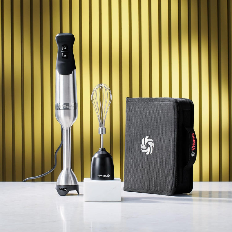Vitamix | Immersion Blender Bundle with whisk and storage case on a table, showcasing versatile blending tools perfect for any kitchen enthusiast.