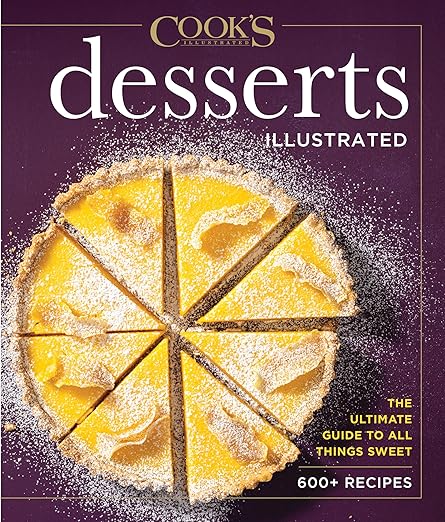 Cover of Desserts Illustrated cookbook featuring a pre-sliced lemon tart. Offers 600+ sweet recipes as the ultimate dessert guide.