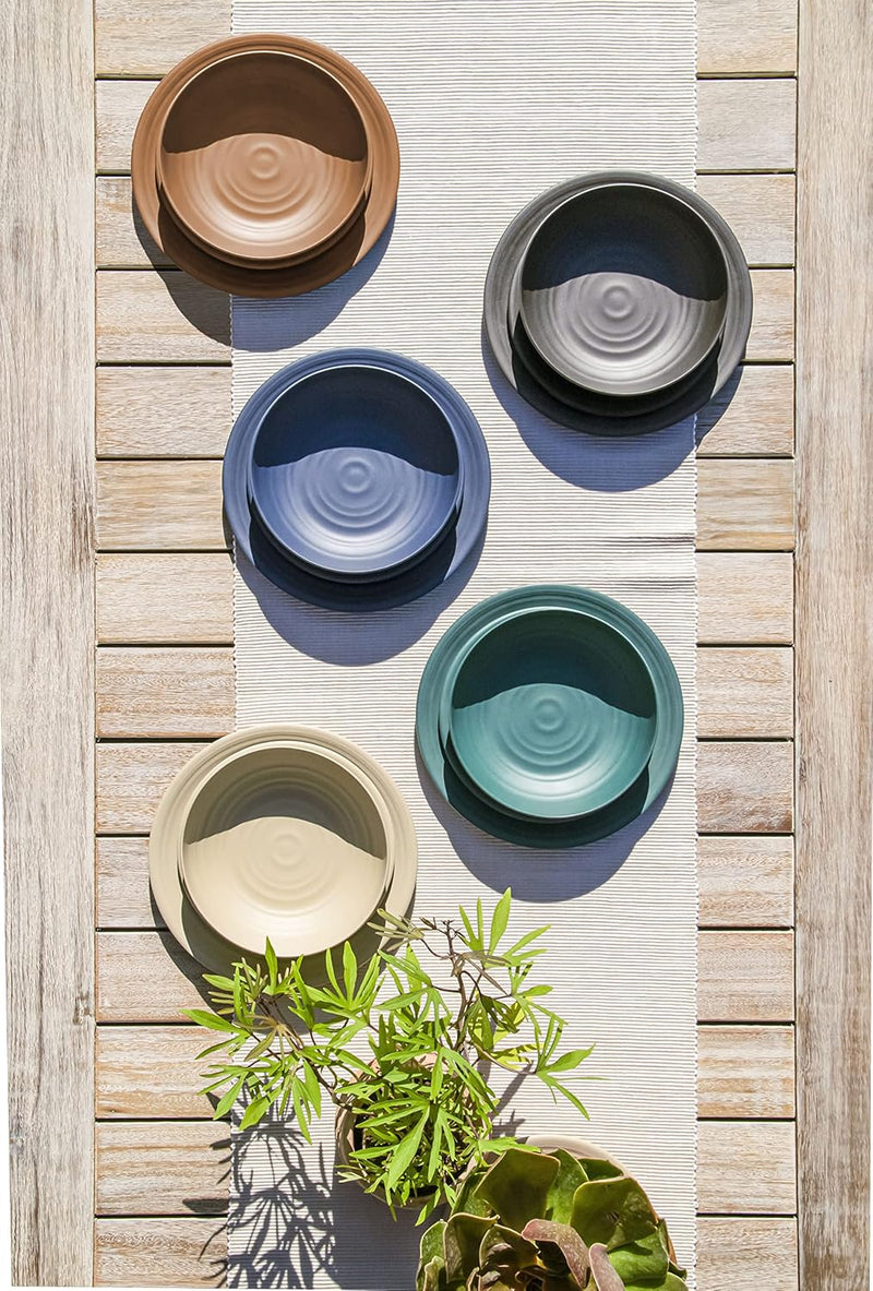TarHong | Planta Matte Low Bowl - Black; a durable, shatterproof plant-based bowl with a ceramic look, ideal for sustainable dining, featured among other tableware.