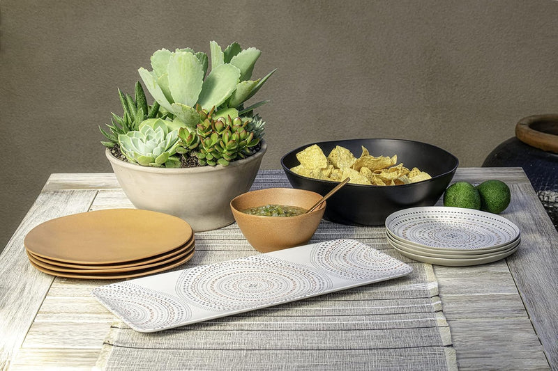 TarHong | Planta Matte Low Bowl - Black, an 8 sustainable, shatterproof bowl perfect for eco-friendly dining, showcased on a table with complementary plates.