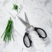 Messermeister - Take-Apart Kitchen Scissors - 8: Red, shown cutting chives, featuring black handles suitable for all users and multifunctional kitchen utility design.