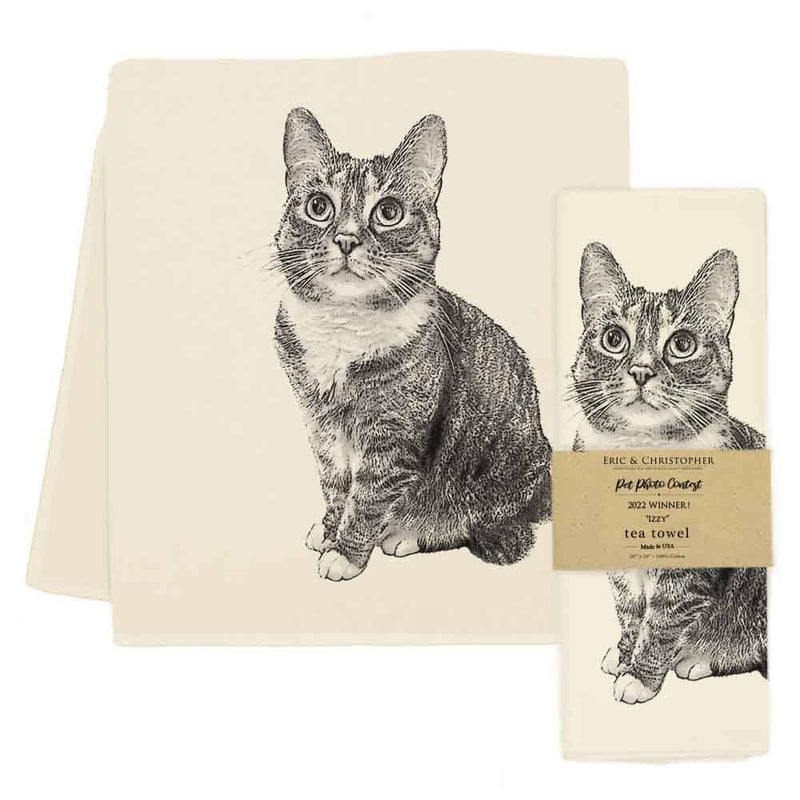 Eric & Christopher - Cat Tea Towel - Izzy, features a tabby cat portrait, folded and unfolded, with a kraft-paper band noting its award-winning design.
