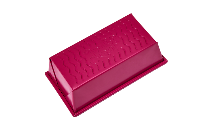 Great Jones | Breadwinner - Raspberry loaf pan with a wavy, nonstick bottom, perfect for baking. Features nontoxic ceramic coating and embossed design.