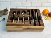Loudblade - Custom Solid Walnut Wooden Flatware Drawer Organizer on countertop, holding flatware, with nearby fruit and decor.