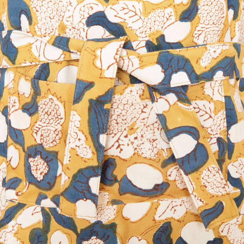 Couleur Nature - Forest Harvest Mustard & Blue Apron detail with self-fabric tie and pocket, featuring hand-printed abstract floral design inspired by Provençal forests.