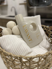L'AVANT Collective - Laundry Detergent Fresh Linen in a basket with towels and dryer balls, perfect for eco-friendly and gentle laundry care.