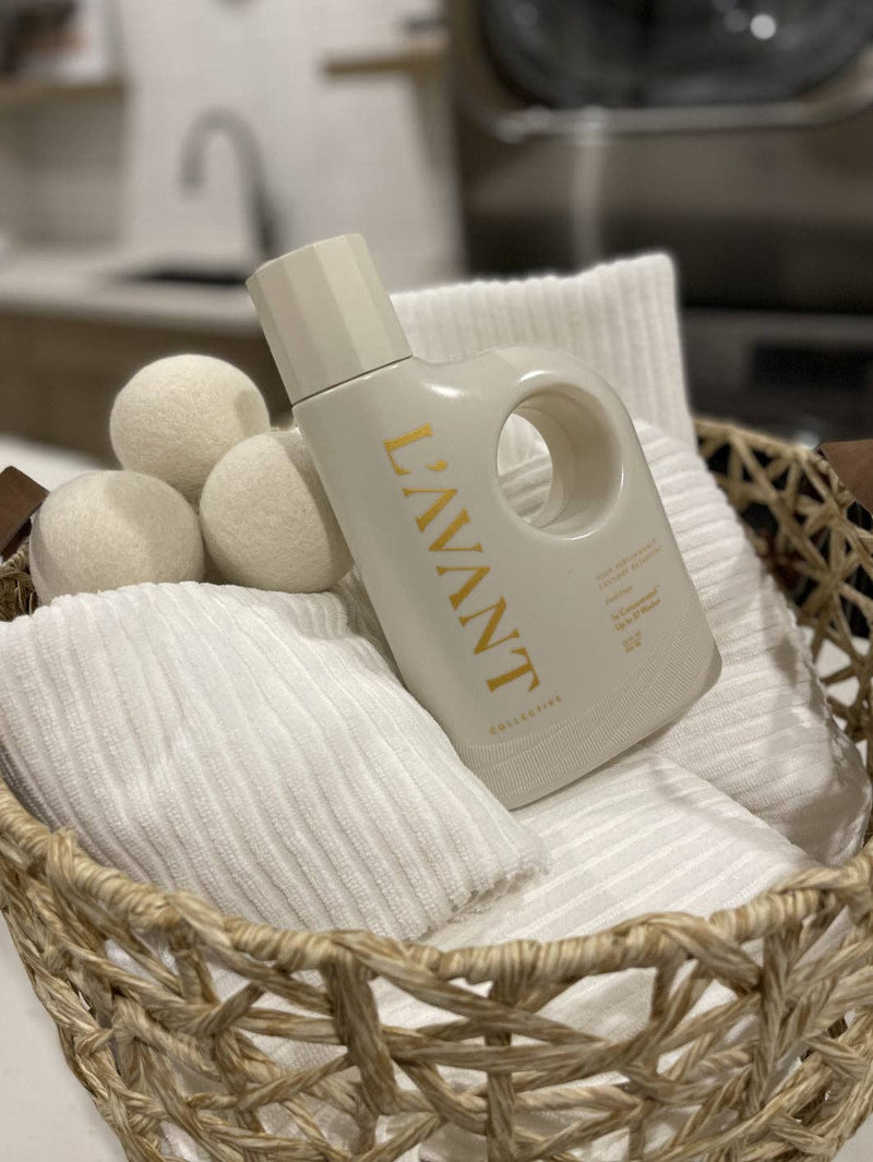 L'AVANT Collective - Laundry Detergent Fresh Linen in a basket with towels and dryer balls, perfect for eco-friendly and gentle laundry care.