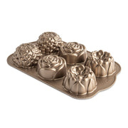 Nordic Ware | Floral Cakelet Pan featuring six flower-shaped molds for baking miniature Bundt cakes, crafted from durable cast aluminum with nonstick interior for easy release.