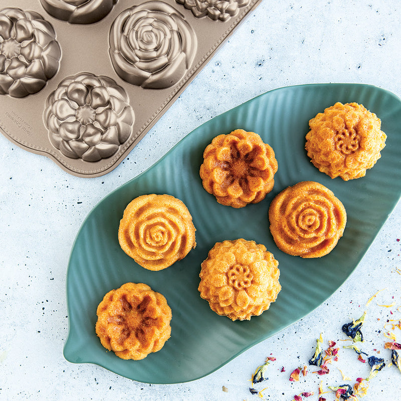 Nordic Ware | Floral Cakelet Pan featuring mini flower-shaped Bundt® cakes. Ideal for special events, crafted from durable cast aluminum for even baking.