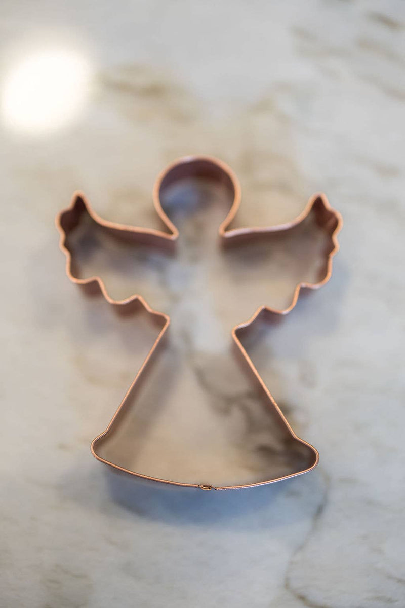 Galley and Fen - Christmas Cookie Cutters - Set of 6 featuring an angel-shaped copper cutter on marble, ideal for festive baking and decorating.