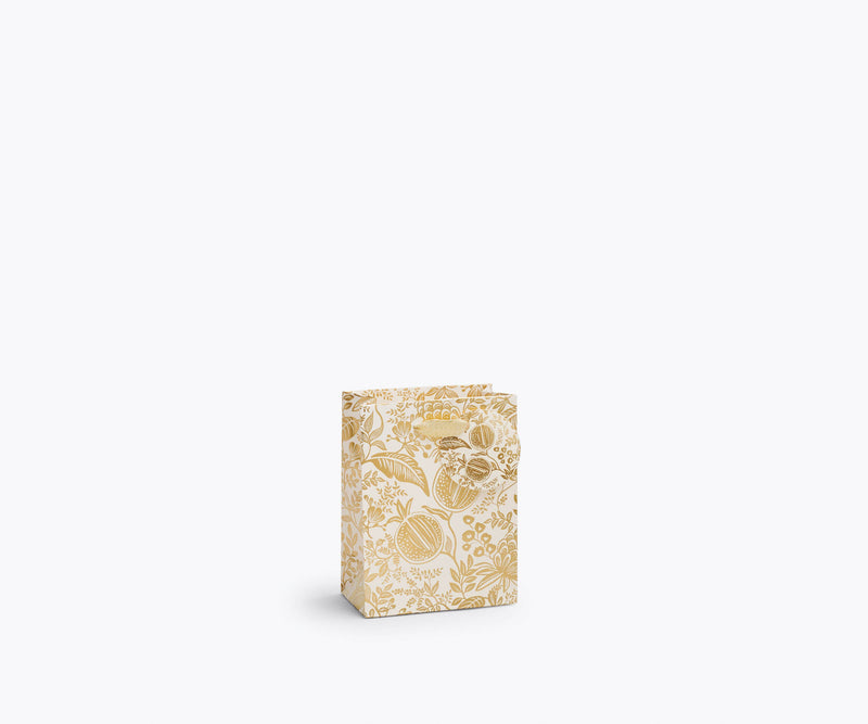 Rifle Paper Co. - Pomegranate Gift Bag: Wine, showcasing a pale golden-yellow botanical motif, metallic ribbon handles, and a coordinating tag, perfect for elegant gifting.
